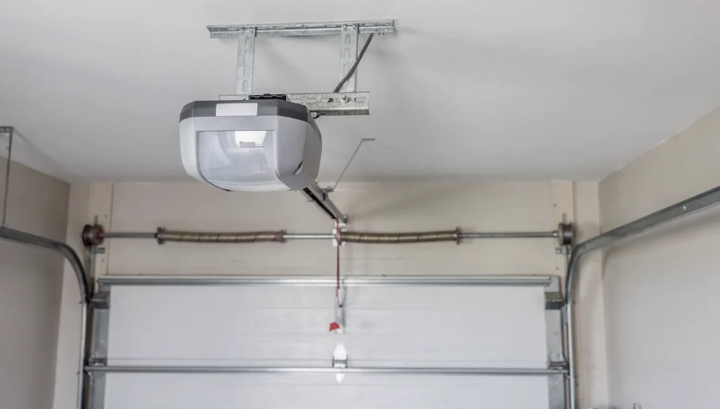 Rectangular garage door opener power head with a horizontal steel rail and trolley installed in a garage, Perth